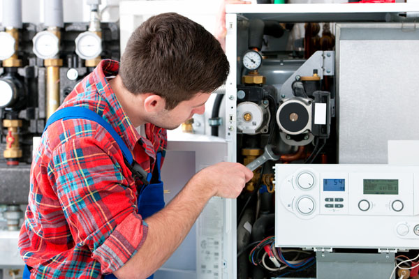 Heating technician repairing boiler controls in Walnut