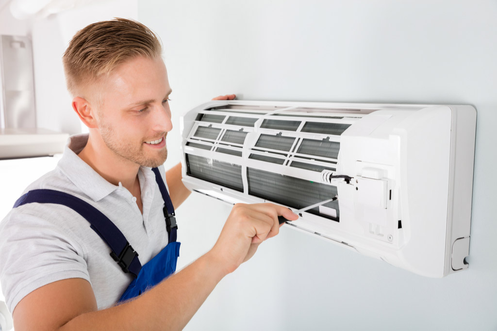 HVAC technician maintaining a ductless air conditioner in Walnut