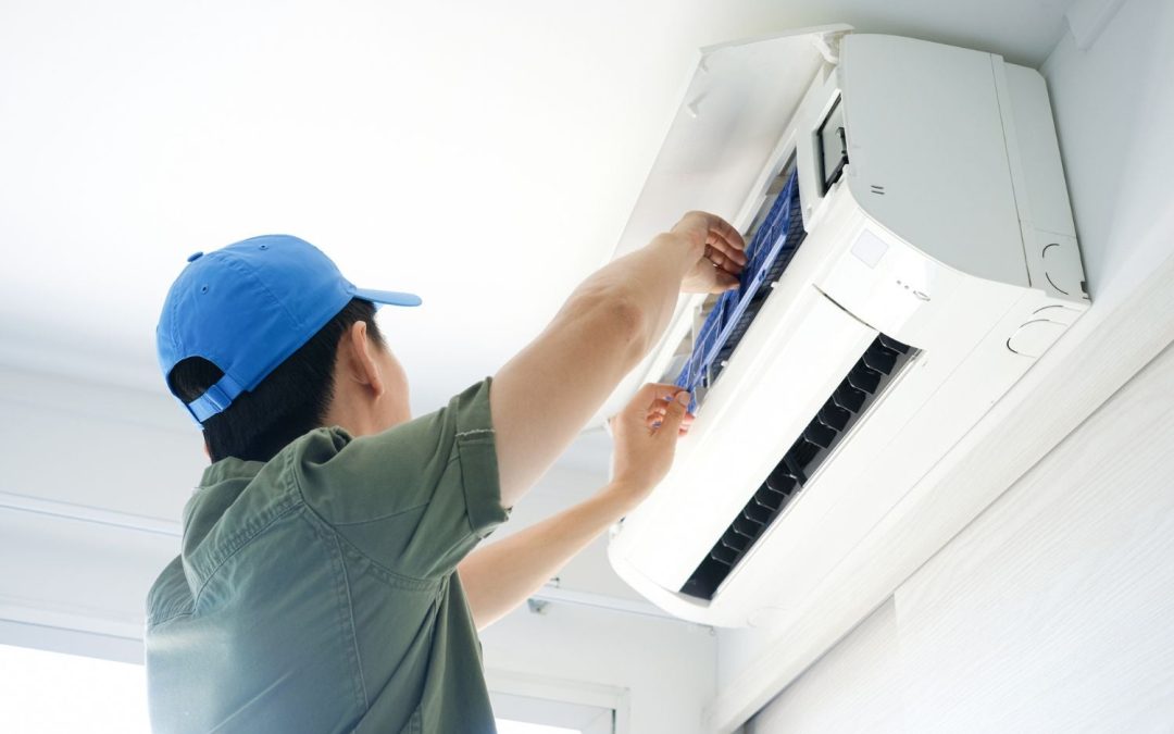 HVAC technician servicing a ductless mini split in Walnut