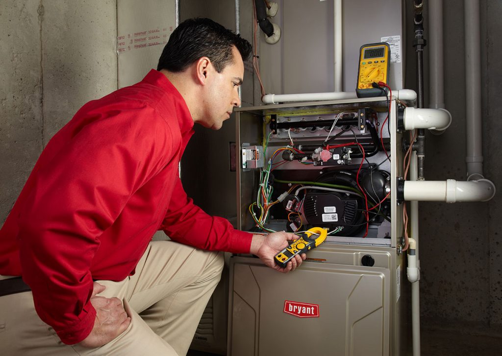 Heating technician diagnosing a furnace repair in Walnut