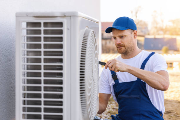HVAC technician servicing an outdoor air conditioner in Walnut
